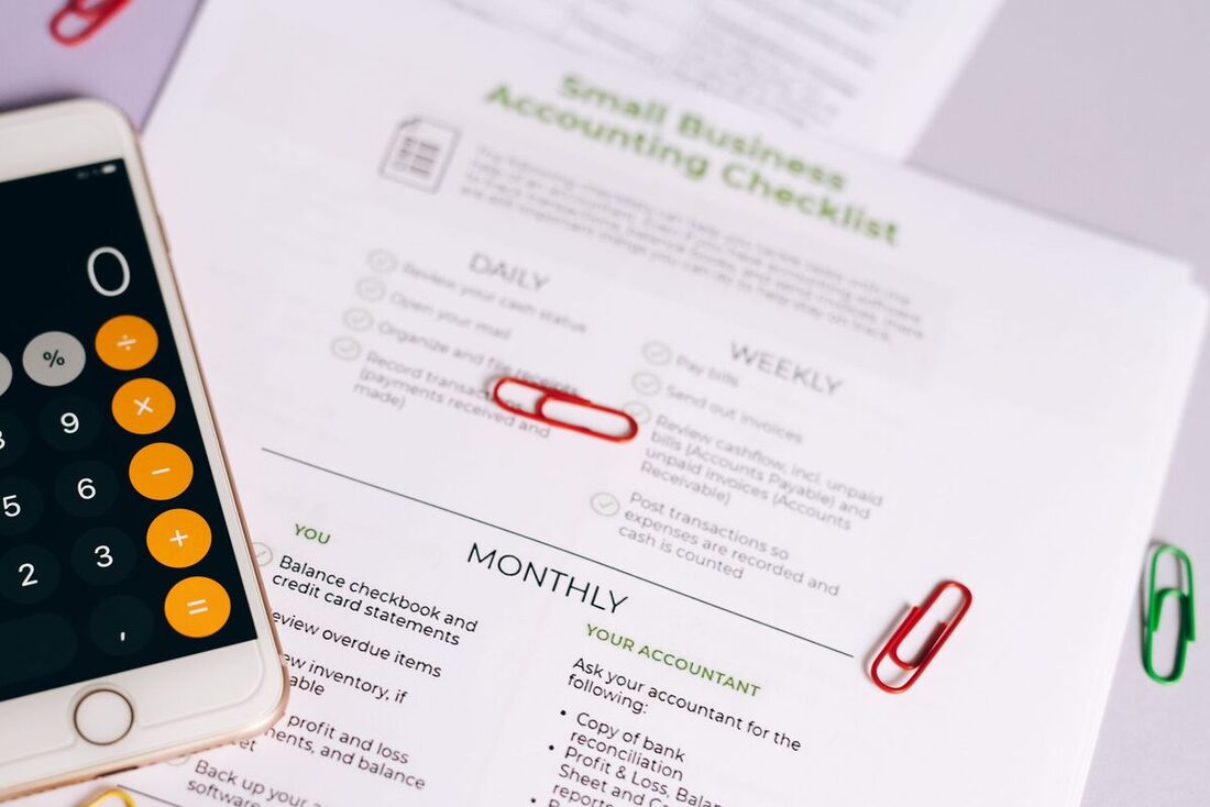 Small-business accounting checklist with a calculator