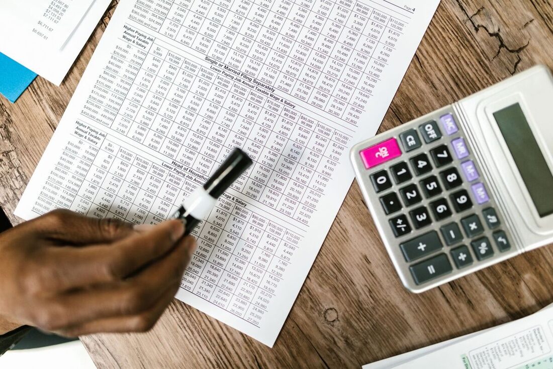 Reviewing a financial spreadsheet beside a calculator