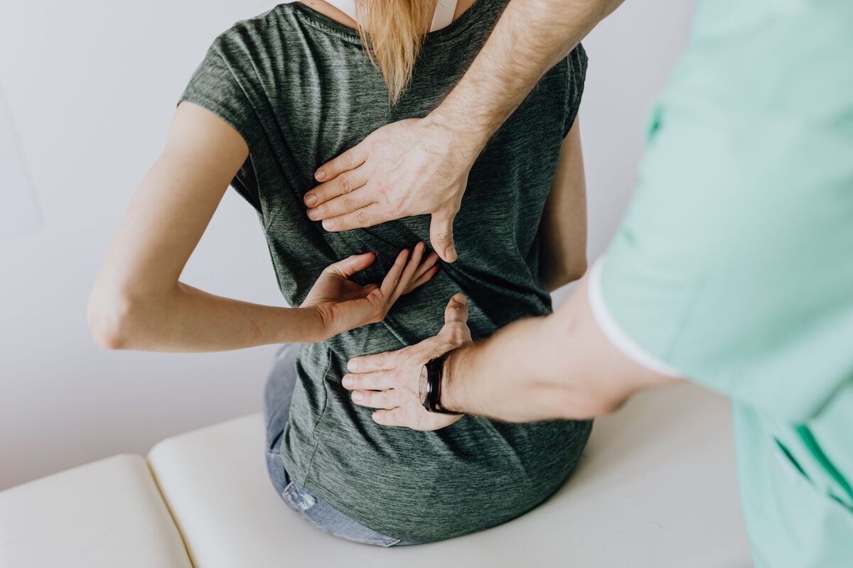Chiropractor assessing a patient's spine