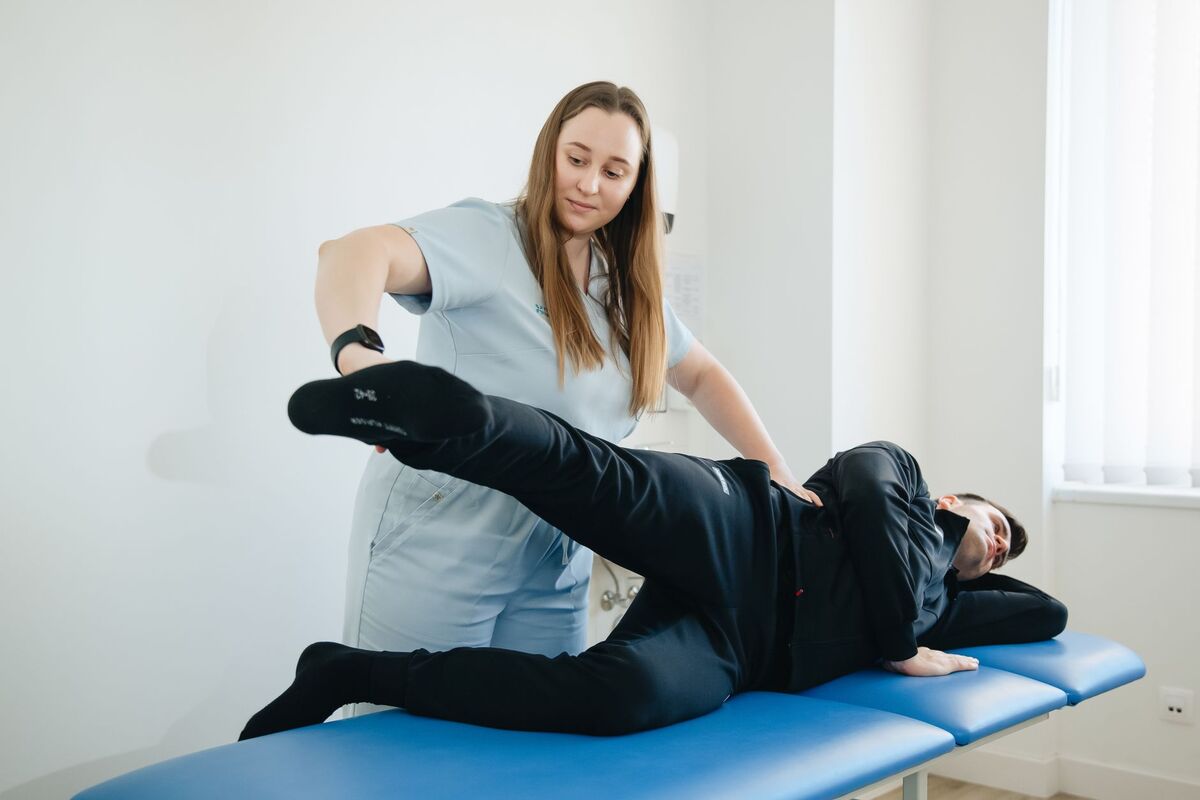 Chiropractor guiding a patient through a mobility assessment