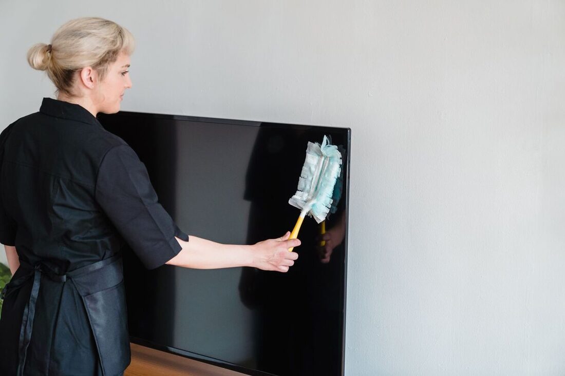 Cleaner dusting in a home