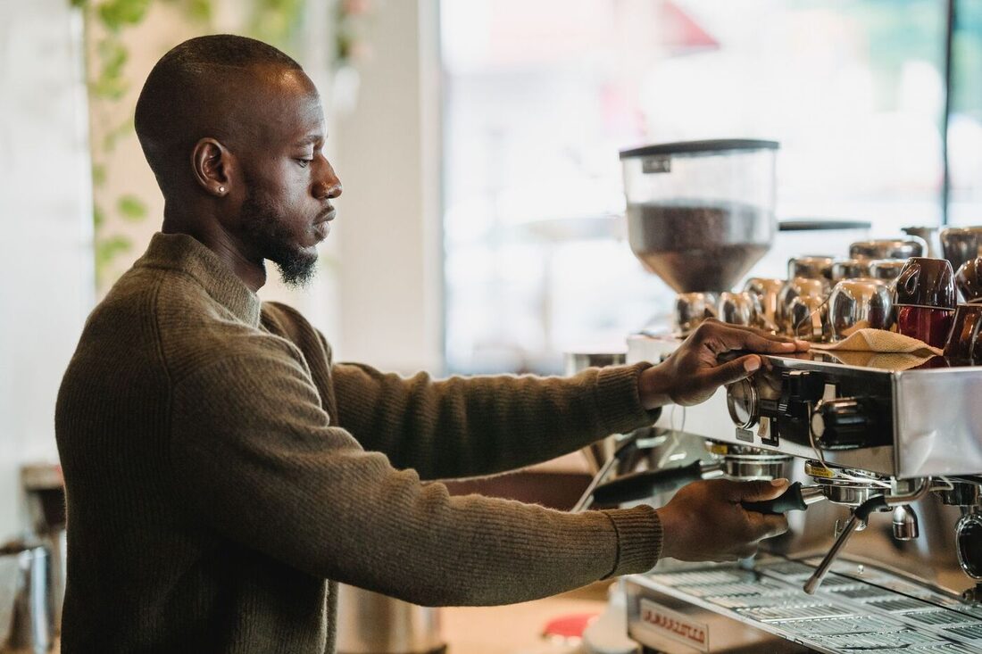 Barista pulling espresso in a warm Nashville café