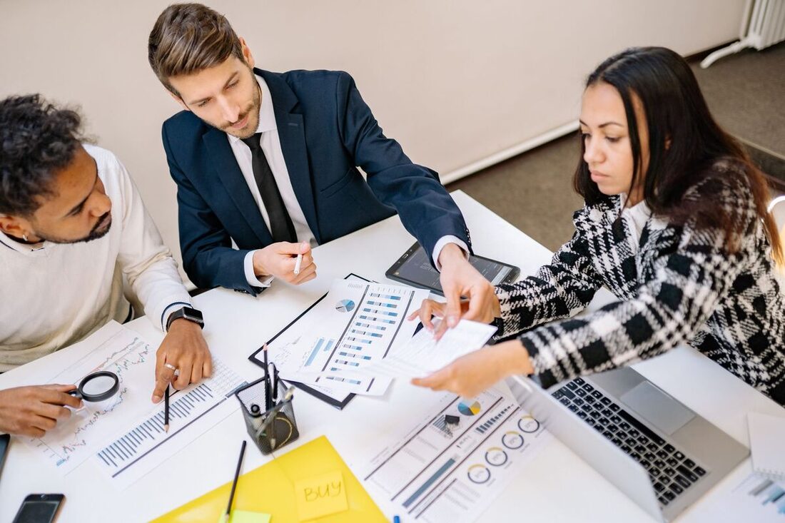Consultants reviewing data and reports at a desk