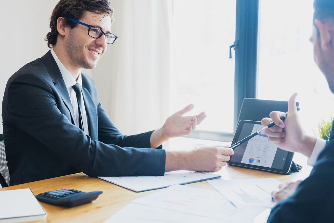 CPA meeting a client over financial documents in a Nashville office