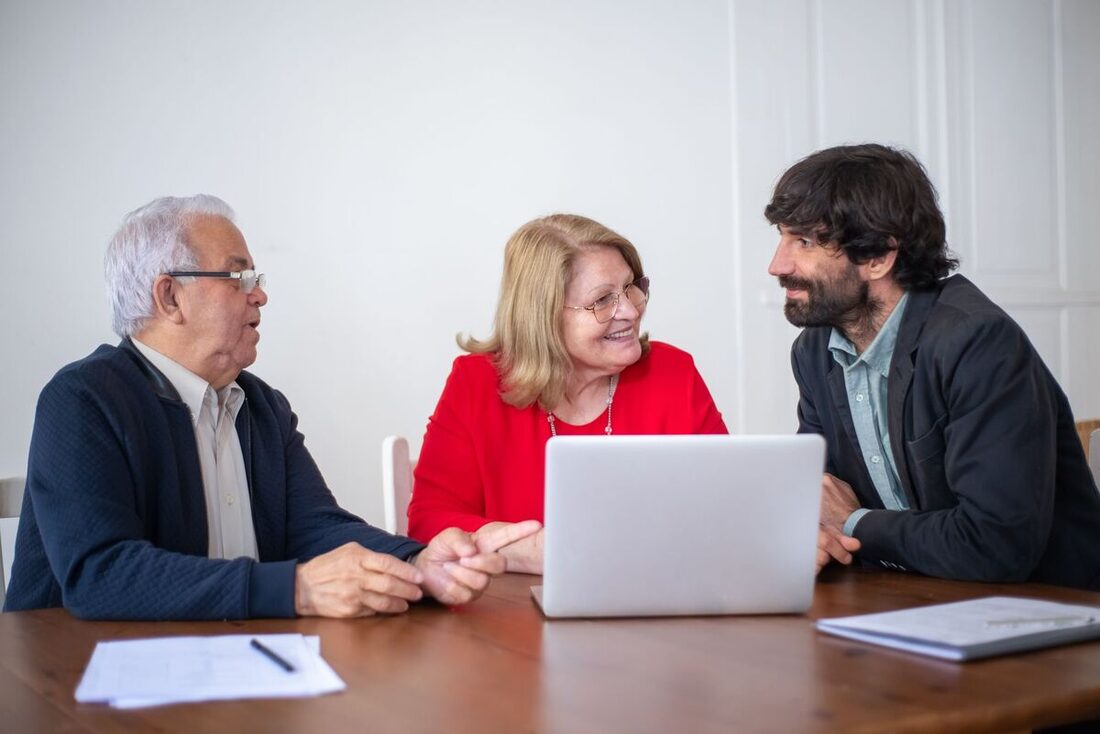 CPA advising clients at a laptop