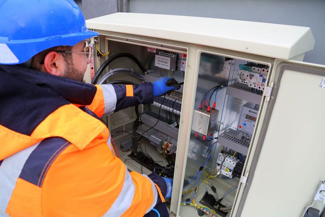 Electrical contractor servicing an outdoor electrical cabinet