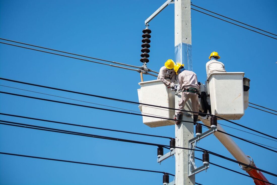 Line crew working from a bucket lift on power infrastructure