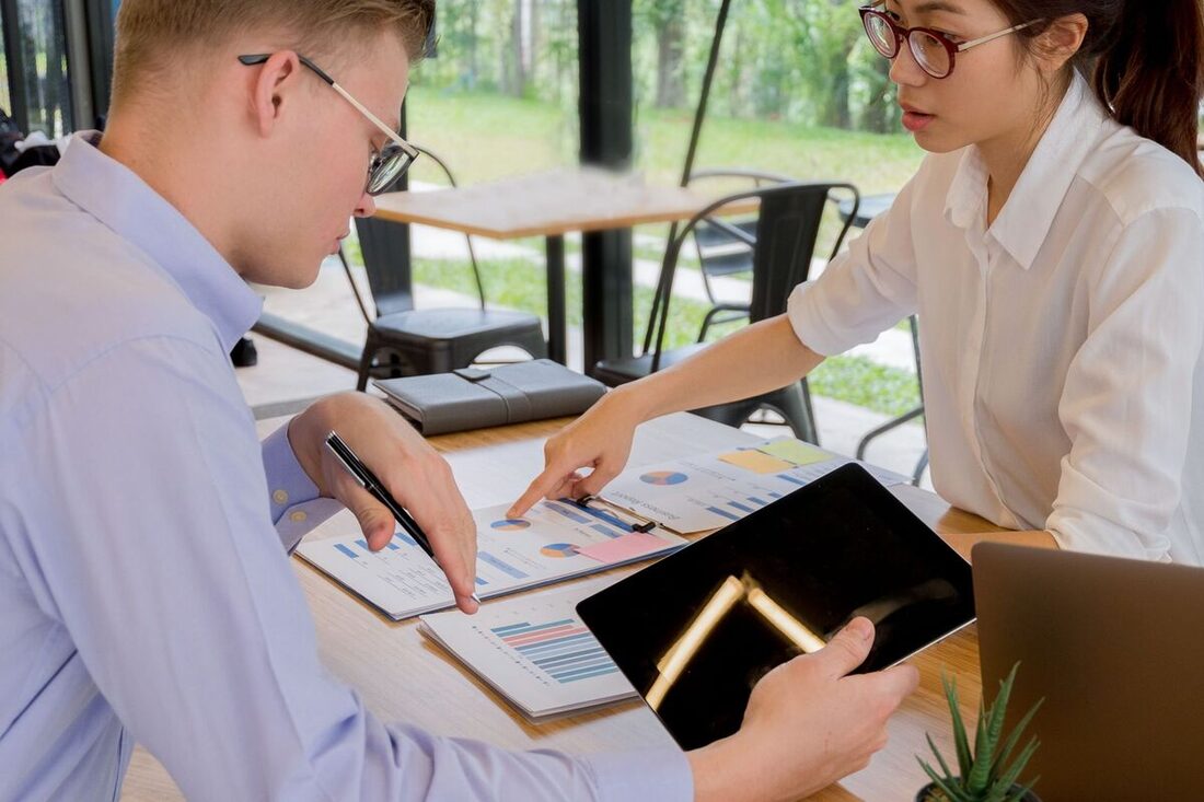 Advisors analyzing financial charts on a tablet