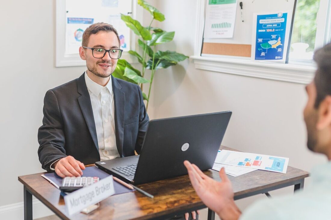 Financial consultant advising a client at a desk