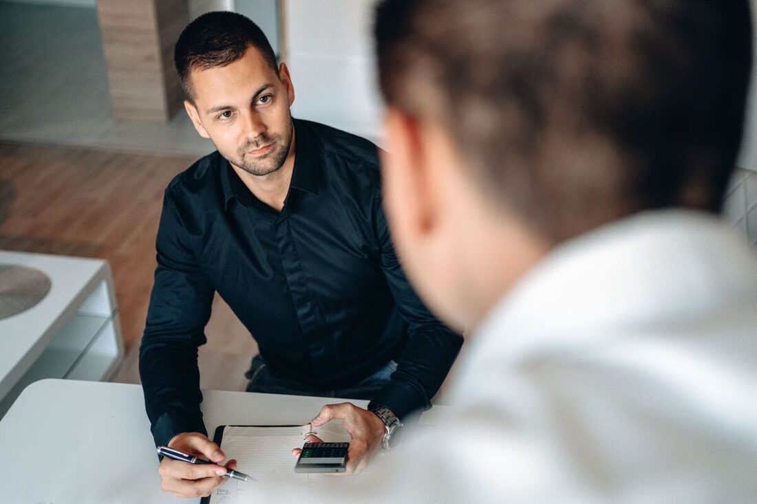 Advisors presenting market charts on a screen