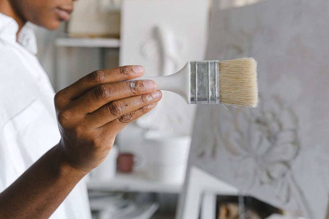Professional painter inspecting a paint brush