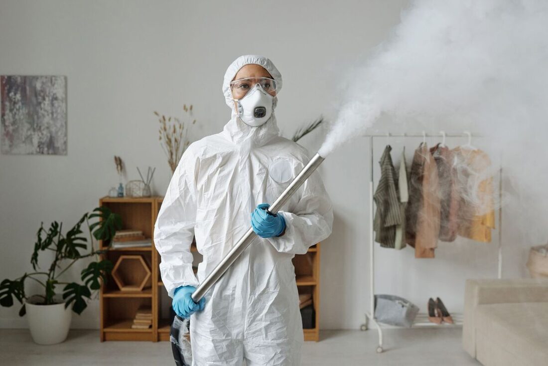 Technician fogging treatment inside a home