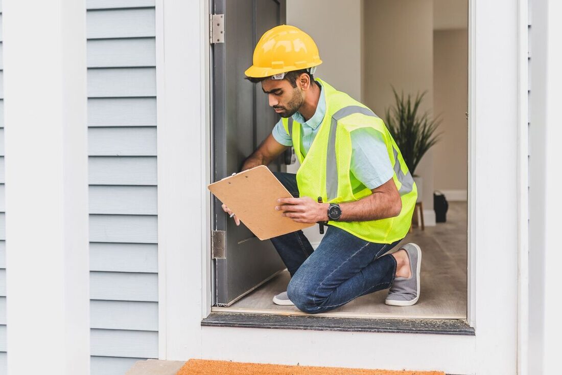 Pest control inspector examining a home's entry point