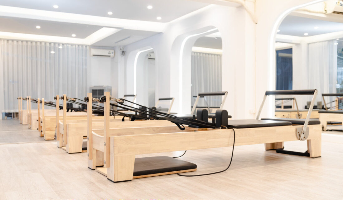 Row of reformers in a bright Nashville Pilates studio