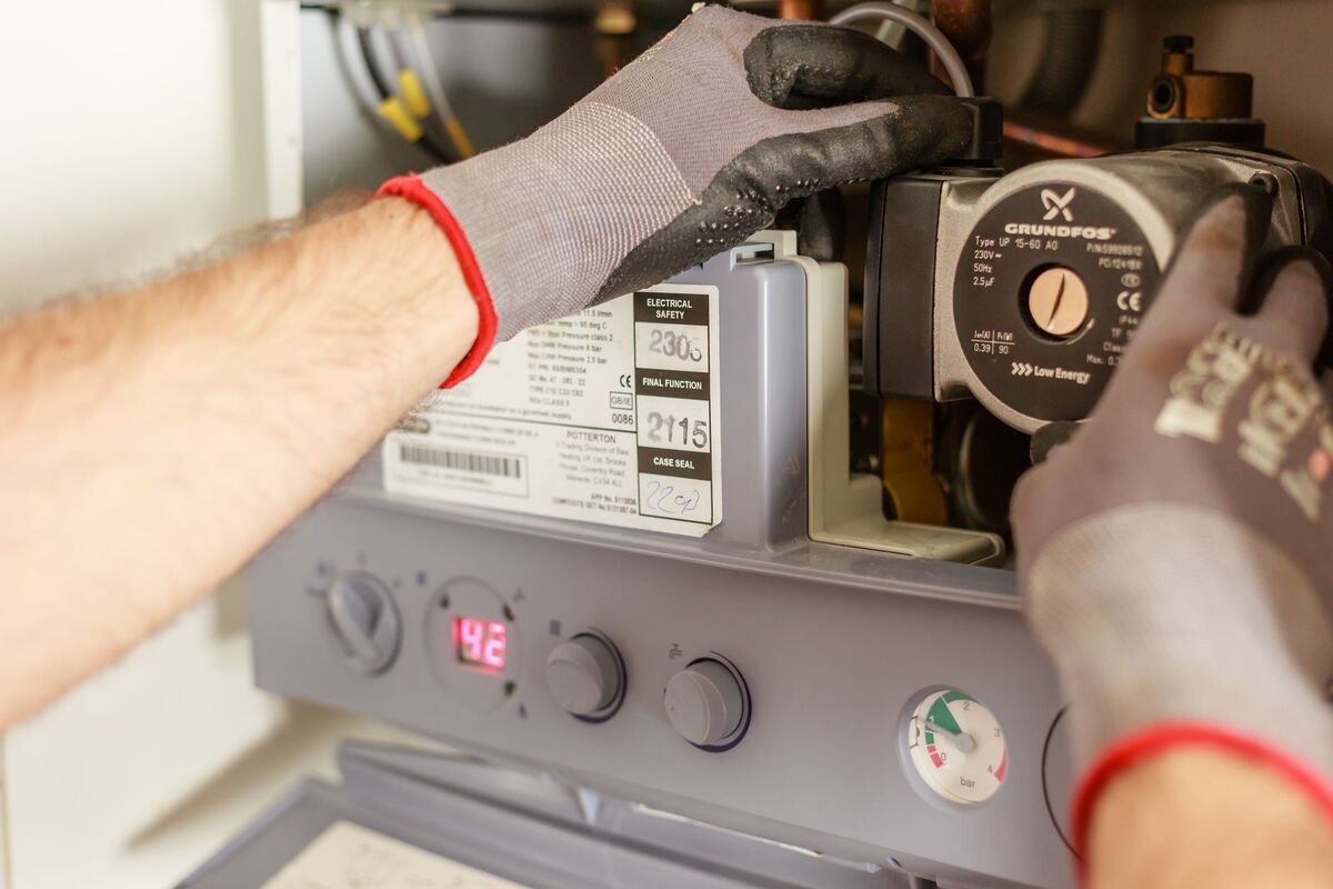 Plumber servicing a water heater system