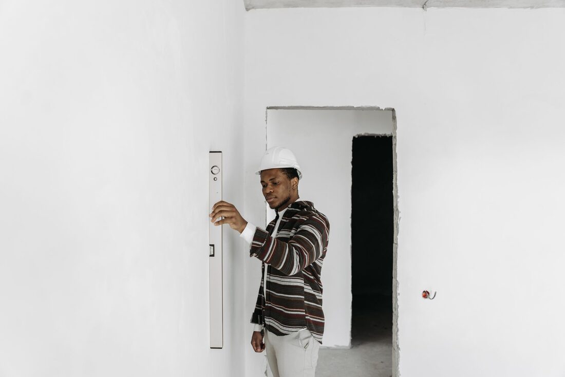 Remodeling contractor checking a wall with a level