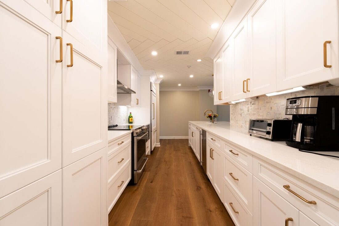 Finished white kitchen remodel with gold hardware