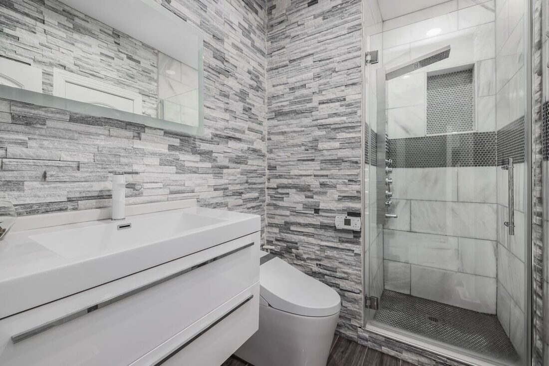 Finished modern bathroom remodel with glass shower