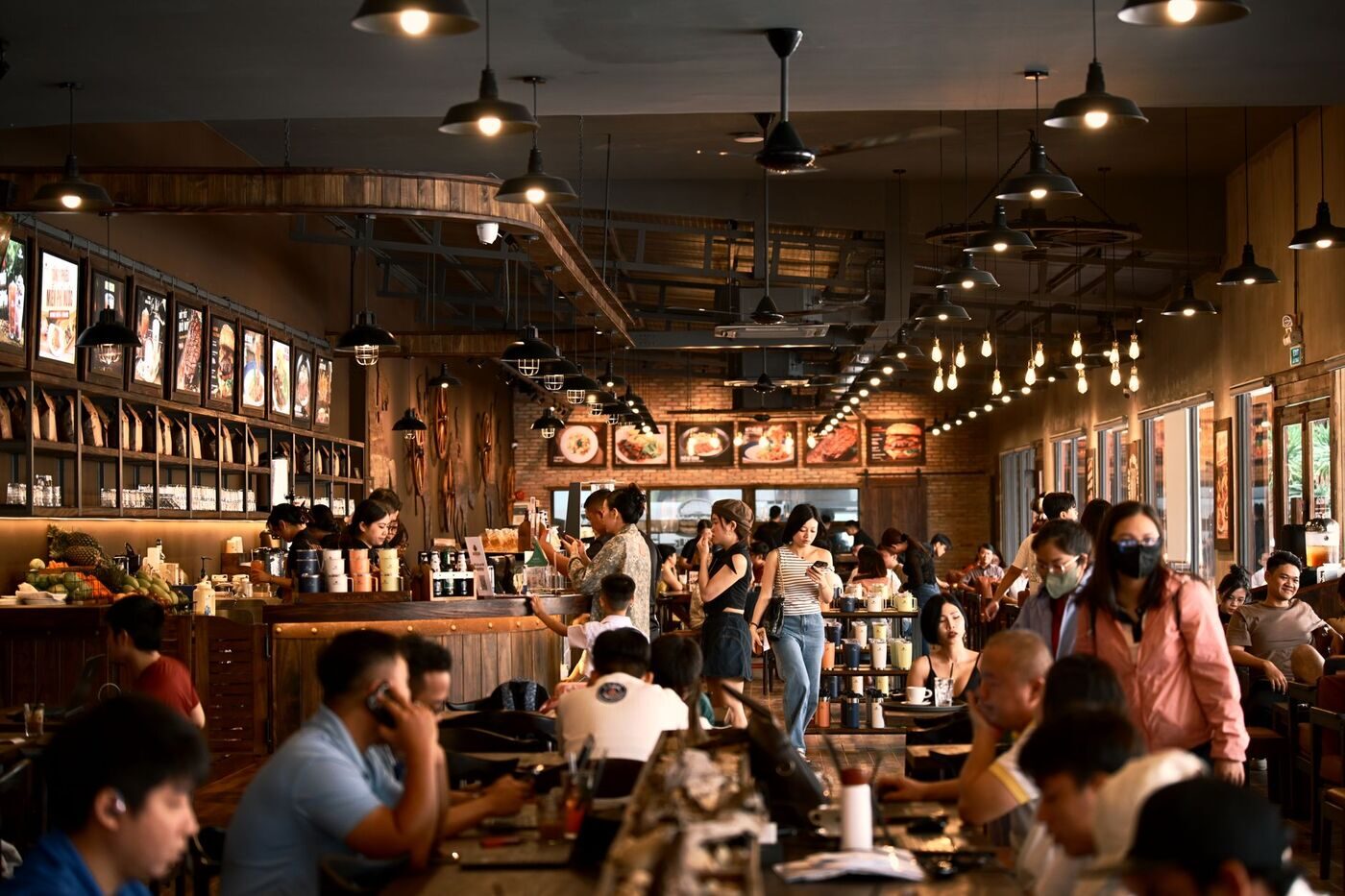 A warm, busy Nashville restaurant dining room full of guests