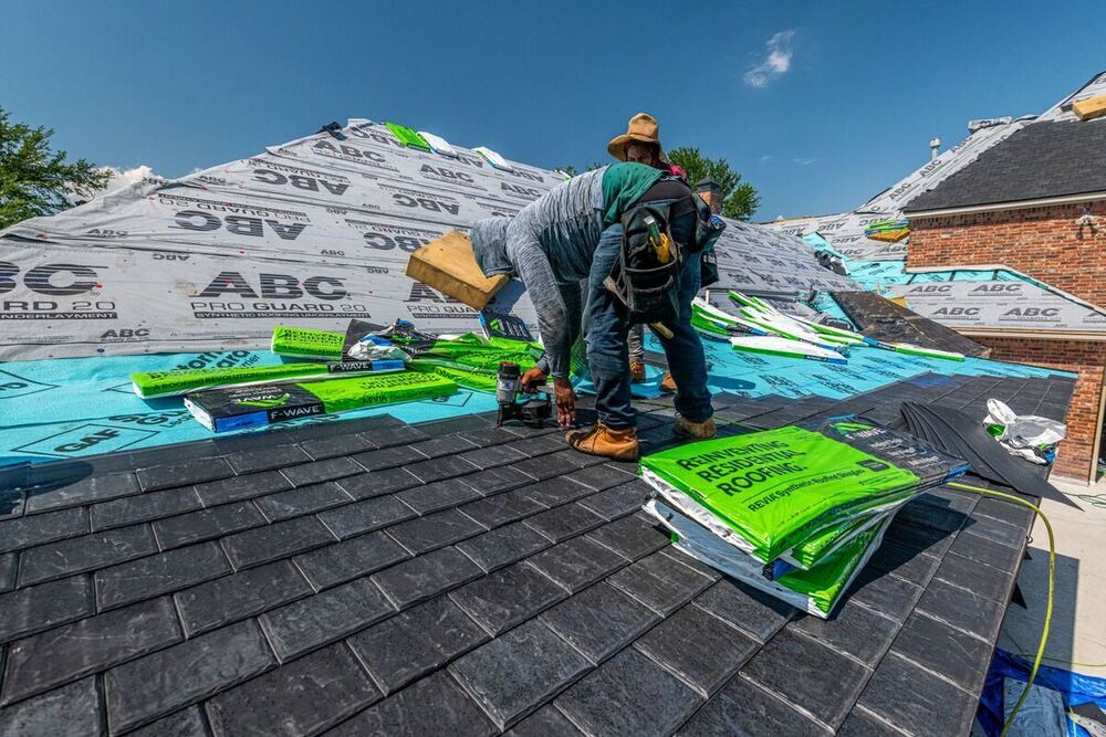 Roofers installing shingles on a Nashville home