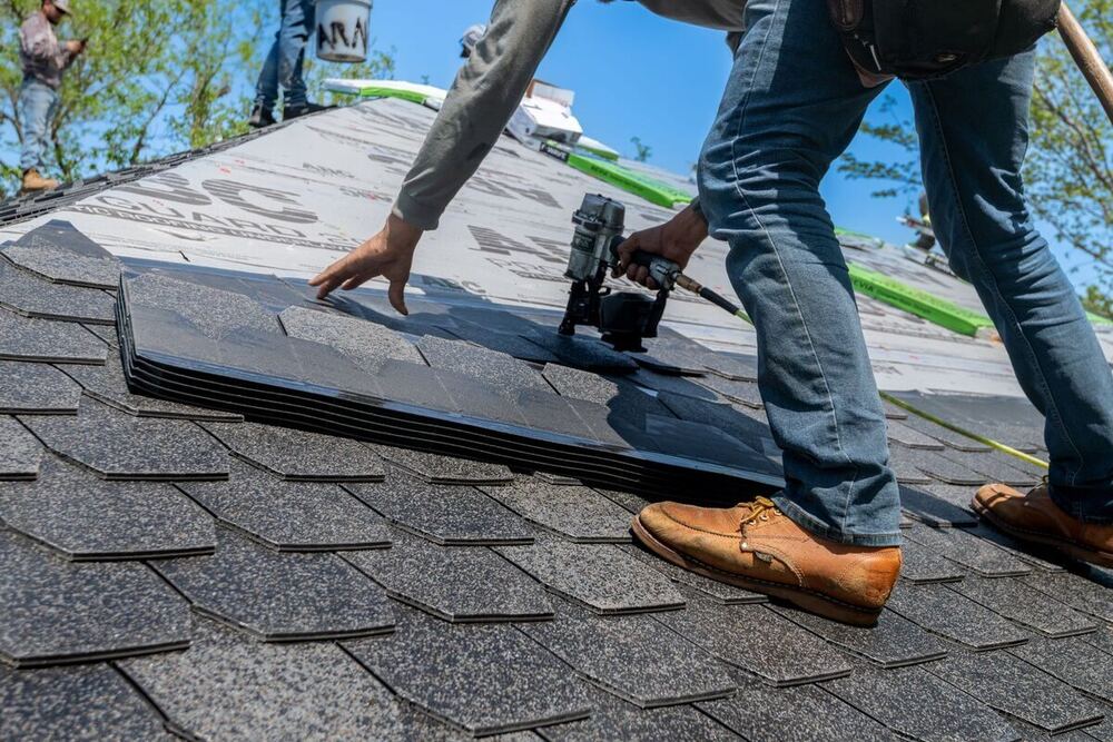 Roofer performing a roof repair