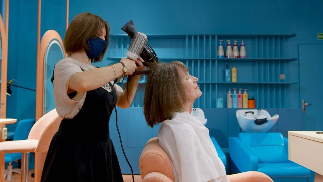 Stylist blow-drying a client in a modern Nashville salon